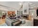 Open concept living room showcasing a fireplace, built-in shelves, and seamless access to the kitchen at 530 Twinflower Ct, Roswell, GA 30075