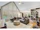 Bright living room with vaulted ceilings, large windows, and open floor plan leading to the kitchen at 530 Twinflower Ct, Roswell, GA 30075