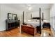 Elegant main bedroom with a four-poster bed, hardwood floors, and ample natural light at 530 Twinflower Ct, Roswell, GA 30075