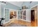 Office space with french doors, custom shelves, and easy access to the living area at 530 Twinflower Ct, Roswell, GA 30075