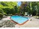 Inviting pool with basketball hoop and lush landscaping, perfect for relaxing or entertaining guests at 530 Twinflower Ct, Roswell, GA 30075