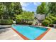 Lush landscaping surrounds the pool with outdoor furniture creating a perfect summer entertainment spot at 530 Twinflower Ct, Roswell, GA 30075