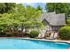 Swimming pool and deck with lounge chairs, umbrellas, and a home with a deck in background at 530 Twinflower Ct, Roswell, GA 30075