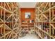 A temperature-controlled wine cellar with racks, showcasing an extensive collection at 530 Twinflower Ct, Roswell, GA 30075