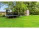 A sprawling backyard with a trampoline and storage shed offers plenty of room for outdoor activities and storage at 1176 Cardinal Ne Rd, Conyers, GA 30012