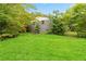 The spacious, well-maintained backyard offers ample space for recreation and outdoor enjoyment, surrounded by mature trees at 1176 Cardinal Ne Rd, Conyers, GA 30012
