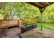 Cozy backyard with a covered patio, deck, and lush greenery provides a perfect outdoor space for entertaining and relaxation at 1176 Cardinal Ne Rd, Conyers, GA 30012