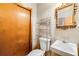 Powder room featuring a wood door, and modern style sink and toilet at 1176 Cardinal Ne Rd, Conyers, GA 30012