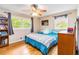 Bright bedroom featuring hardwood floors, a ceiling fan, and plenty of natural light at 1176 Cardinal Ne Rd, Conyers, GA 30012