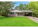 Well-maintained single-story home with a lush green lawn and gray brick facade at 1176 Cardinal Ne Rd, Conyers, GA 30012