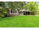 Quaint single-story home surrounded by mature trees and a well-manicured lawn at 1176 Cardinal Ne Rd, Conyers, GA 30012
