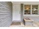 Close-up of the front door with gray brick facade and a small planter box at 1176 Cardinal Ne Rd, Conyers, GA 30012