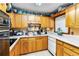 Classic kitchen features wood cabinets, white counters, and modern appliances at 1176 Cardinal Ne Rd, Conyers, GA 30012