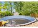 Above-ground pool with deck is ready for summer fun, offering a refreshing escape in the privacy of your backyard at 1176 Cardinal Ne Rd, Conyers, GA 30012