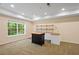 Finished basement area with carpet, bar area, stainless steel sink and large window at 2595 Glaramara Ter, Cumming, GA 30041