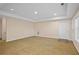 Finished basement area with carpet flooring, recessed lighting, and white doors at 2595 Glaramara Ter, Cumming, GA 30041