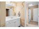 Bathroom with a white vanity and sink, a large mirror, and access to the toilet and shower at 2595 Glaramara Ter, Cumming, GA 30041