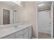 Bathroom with white vanity and sink, large mirror, and a view of the toilet and shower at 2595 Glaramara Ter, Cumming, GA 30041