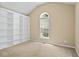 Bedroom featuring neutral carpet, built-in shelving, and a bright window at 2595 Glaramara Ter, Cumming, GA 30041