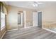 Bright room with mural, new flooring, ceiling fan and multiple doorways leading to other areas at 2595 Glaramara Ter, Cumming, GA 30041