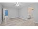 Neutral bedroom with new flooring, a ceiling fan, with doorways to other rooms and bathroom at 2595 Glaramara Ter, Cumming, GA 30041