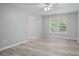 Spacious room with new flooring, a ceiling fan, and a bright window with tree views at 2595 Glaramara Ter, Cumming, GA 30041