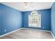 Vibrant bedroom with new flooring, arched window providing natural light and ceiling fan at 2595 Glaramara Ter, Cumming, GA 30041