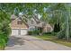 Charming two-story home with a stone facade, manicured lawn, and a two-car garage at 2595 Glaramara Ter, Cumming, GA 30041