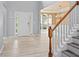 Inviting foyer with wood-look tile flooring, stairs, and a view of the dining room at 2595 Glaramara Ter, Cumming, GA 30041