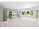 Eat-in kitchen with stainless refrigerator, kitchen island, and lots of natural light at 2595 Glaramara Ter, Cumming, GA 30041