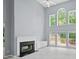 Bright living room with fireplace, built-ins, and large windows at 2595 Glaramara Ter, Cumming, GA 30041