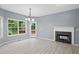 Living room featuring fireplace, wood-look floors, and light-filled views at 2595 Glaramara Ter, Cumming, GA 30041