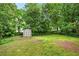 The backyard features lush green grass and a storage shed among mature trees at 3288 Dogwood St, Atlanta, GA 30337