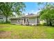 Expansive backyard featuring a cozy deck, lush grass, and partial fencing, perfect for outdoor relaxation at 3288 Dogwood St, Atlanta, GA 30337