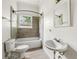 Bathroom featuring tiled walls, toilet, sink, mirror and a bathtub at 3288 Dogwood St, Atlanta, GA 30337