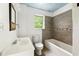 Bathroom featuring wood tile, toilet, vanity, window and a bathtub at 3288 Dogwood St, Atlanta, GA 30337
