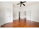 Bedroom featuring hardwood floors, neutral walls, ceiling fan and multiple access doors at 3288 Dogwood St, Atlanta, GA 30337