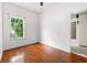 Bedroom featuring hardwood floors, neutral walls, window and access to the bathroom at 3288 Dogwood St, Atlanta, GA 30337