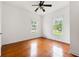 Bedroom featuring hardwood floors, neutral walls, windows and ceiling fan at 3288 Dogwood St, Atlanta, GA 30337
