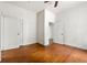 Spacious bedroom featuring hardwood floors, neutral walls, ceiling fan, and a double-door closet at 3288 Dogwood St, Atlanta, GA 30337