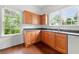 Bright kitchen with wooden cabinets, spacious counters, and natural light from windows at 3288 Dogwood St, Atlanta, GA 30337