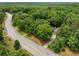 Breathtaking aerial view of the property nestled among mature trees and lush landscaping at 5535 Dorsett Shoals Rd, Douglasville, GA 30135