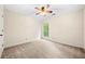 Bedroom with neutral carpet, fan, and window looking out to trees at 5535 Dorsett Shoals Rd, Douglasville, GA 30135