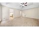 Bedroom with neutral carpet, ceiling fan, and access to other rooms at 5535 Dorsett Shoals Rd, Douglasville, GA 30135