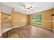 Cozy bedroom featuring light yellow walls, wood floors, and a ceiling fan at 5535 Dorsett Shoals Rd, Douglasville, GA 30135