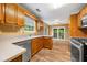 Well-lit kitchen with wooden cabinets, stainless steel appliances, and sliding doors to the outside at 5535 Dorsett Shoals Rd, Douglasville, GA 30135