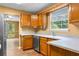 Kitchen view of wooden cabinets, stainless steel dishwasher, and quartz countertops at 5535 Dorsett Shoals Rd, Douglasville, GA 30135