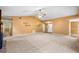 Large living room with a vaulted ceiling, stone fireplace, and neutral carpeting at 5535 Dorsett Shoals Rd, Douglasville, GA 30135