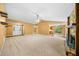 Open-concept living room featuring a vaulted ceiling, stone fireplace, and neutral decor at 5535 Dorsett Shoals Rd, Douglasville, GA 30135