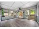 Large screened-in porch with ceiling fan, natural lighting, and access to the outside at 5535 Dorsett Shoals Rd, Douglasville, GA 30135